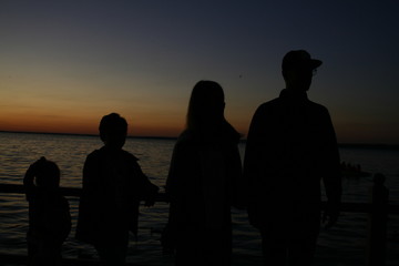 silhouettes of people on the beach