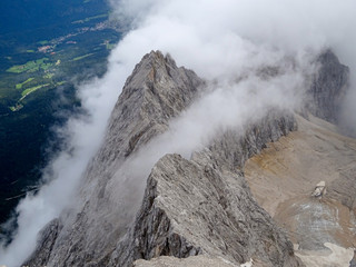 Man Hiking to the top of Germany with a stunning view to the alpine rocks in Germany