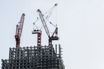 Construction site with cranes on sky background