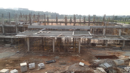 SERDANG, MALAYSIA -JUNE 13, 2016: Construction site in progress at Serdang, Malaysia during the daytime. Workers busy with their task installing formwork and reinforcement bar.    