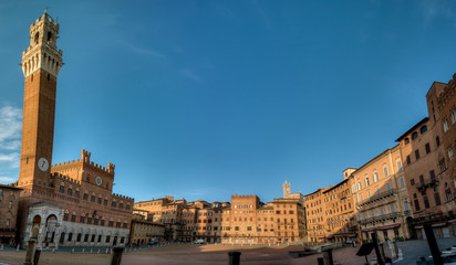 Fototapeta na wymiar panoramique sur Piazza del Campo et son Palazzo Pubblico de la ville de Sienne en Toscane Italie au lever du soleil