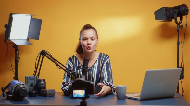 Professional NP-F battery review by new media star in her studio set. Content creator new media star influencer on social media talking professional video photo equipment for online internet web show