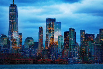 Skyscrapers view of New York Manhattan downtown over Hudson river on moody overcast night