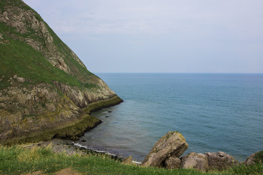Viewpoint from the little Orme in north wales. Calm sea washing into a small rocky bay