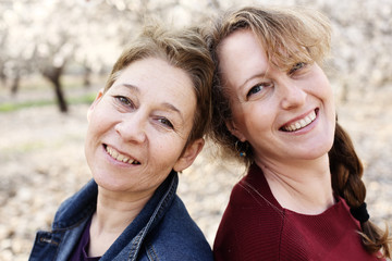 Portrait of two smiling real mature women outdoor