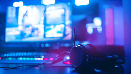 Professional headphones with microphone for video games and cyber sports on background of gaming...