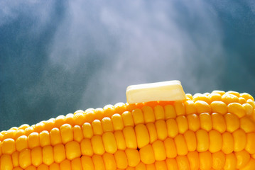 Melting butter on steaming got corncob