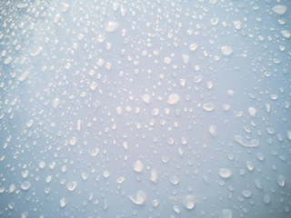Rain drops on car window glasses surface. Natural Pattern of raindrops.