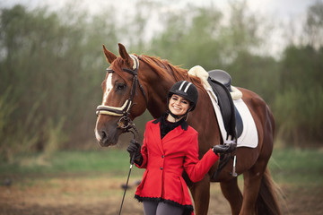 Portrait Jockey woman rider with brown horse, concept advertising equestrian club school