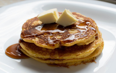 Pancakes stacked with honey and butter