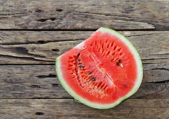 Fototapeta na wymiar Red watermelon on a wooden rustic table. Food background.