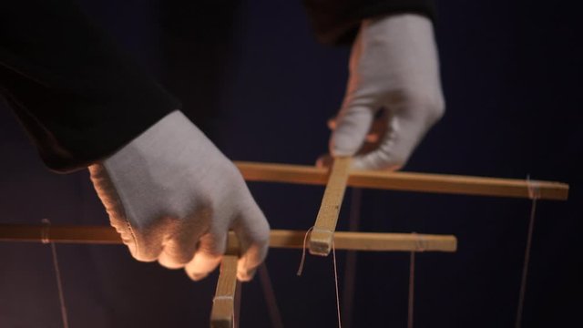 People - puppet dolls marionette controlled from above using wires or strings in the hands of the puppeteer