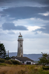 Fototapeta na wymiar Hale village lighthouse during stormy weather