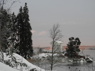 White gazebo in classical style located on the shores of the Gulf of Finland in Mon Repos Park