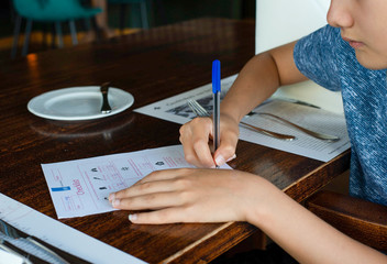 A restaurant guest fill coronavirus registration form in the restaurant to be protected tracing for...