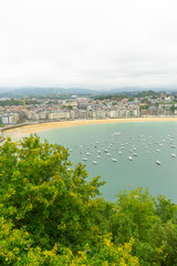 Tourism, view of the city of San Sebastian, with La Concha beach, from Mount Urgull. Summer vacation scene in Spain