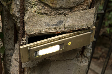 Broken letterbox in the wall without address with text space