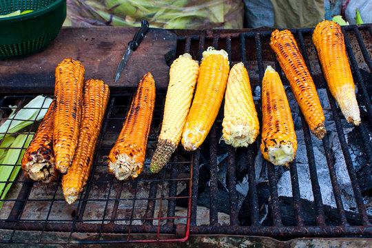 Grilled corn ears on the grille over charcoals on the market, Antigua Guatemala.