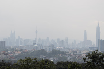 Hazy Kuala Lumpur city skyscape due to  haze from forest fire