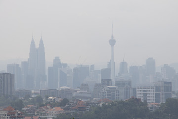 Hazy Kuala Lumpur city skyscape due to  haze from forest fire - obrazy, fototapety, plakaty