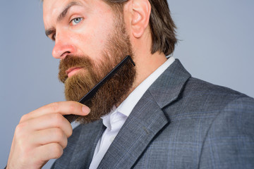 Barbershop advertising. Professional beard care. Hairdresser. Bearded man with comb. Barber-shop....