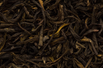Filled abstract background of tea leaves. Black, green tea close up