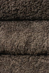 Fototapeta na wymiar Folded brown towels, close-up fabric texture