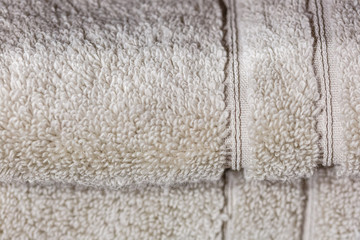 Fototapeta na wymiar Folded white towels, close-up fabric texture