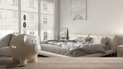 Wooden table top or shelf with white piggy bank with coins, modern white bedroom, expensive home interior design, renovation restructuring concept architecture