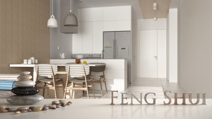 White table shelf with pebble balance and 3d letters making the word feng shui over white minimalist kitchen with dining table and chairs, zen concept interior design