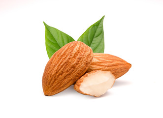 Closeup isolated of fresh almonds nut seed with green leaves on white background.