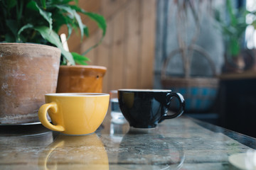 Colorful cups of coffee at the cafe. Stylish glossy crockery.