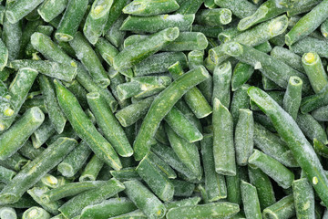 Frozen chopped green string beans texture background. iced beans background for food textures....