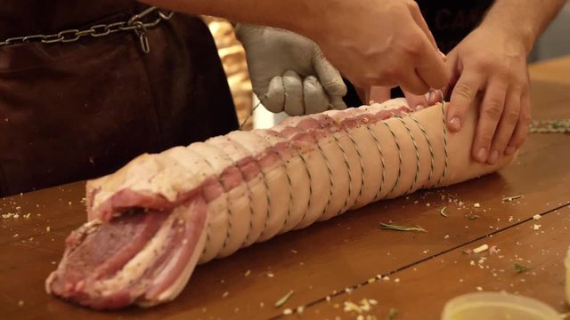 Two men Bandage Raw Big Pork Knuckle with spices. High quality 4k footage