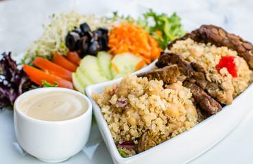 Vegan protein meal on a plate with organic quinoa, tempeh and salad