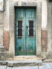 Wooden Weathered Doors With Barred Windows, Bordered By Stone, Braga, Portugal
