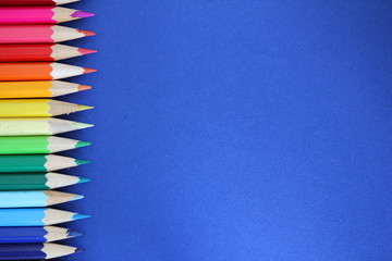 Color pencils on blue cardboard background - place for description