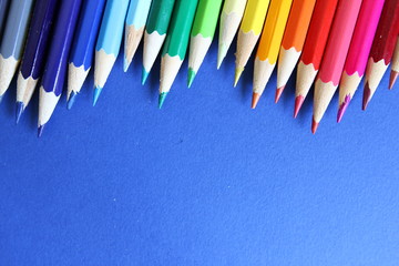 Color pencils on blue cardboard background