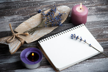 Blank note book, aroma candles and dry lavender