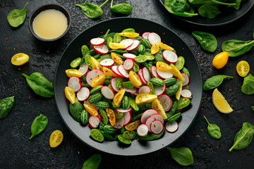 Cucamelon salad with radish, tomato, spinach and mustard dressing. Healthy food.