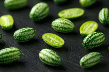 Fresh green Cucamelon on rustic stone board