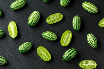 Fresh green Cucamelon on rustic stone board