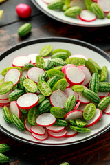 Cucamelon radish salad on rustic wooden table. healthy summer food