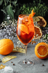 Aperol spritz cocktail on a gray concrete background. a glass of aperol spritz with orange slices....