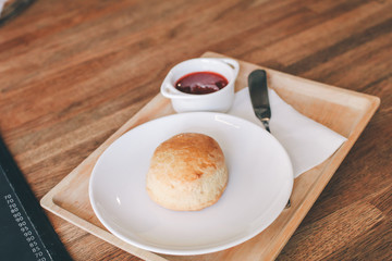 Close-up Homemade delicious English scone set with strawberry jam on the table. Horizontal,copy...