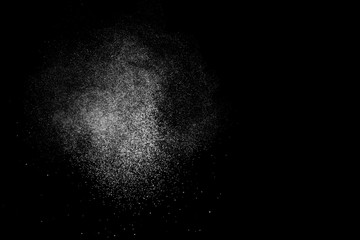 Abstract splashes of water on black background. Freeze motion of white particles. Rain, snow overlay texture.
