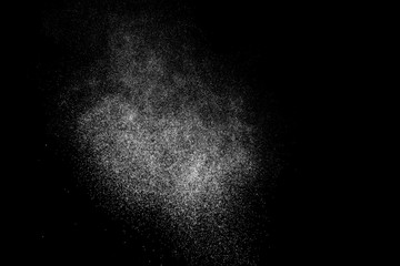 Abstract splashes of water on black background. Freeze motion of white particles. Rain, snow overlay texture.