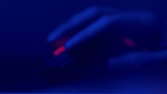 Close up of Hand over wireless Game Mouse on dark background The finger ready to click