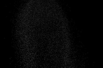 Abstract splashes of water on black background. Freeze motion of white particles. Rain, snow overlay texture.