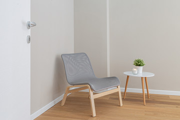 Naklejka na ściany i meble Modern wooden grey chair with a wooden white table in minimal style